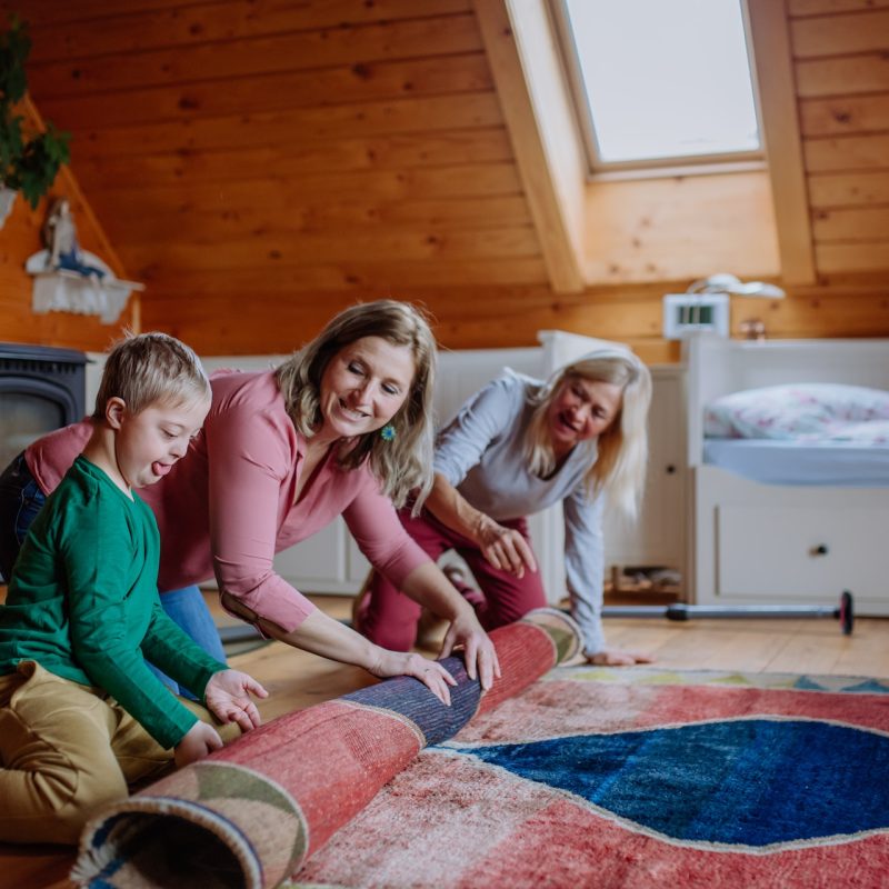 family rolling their carpet